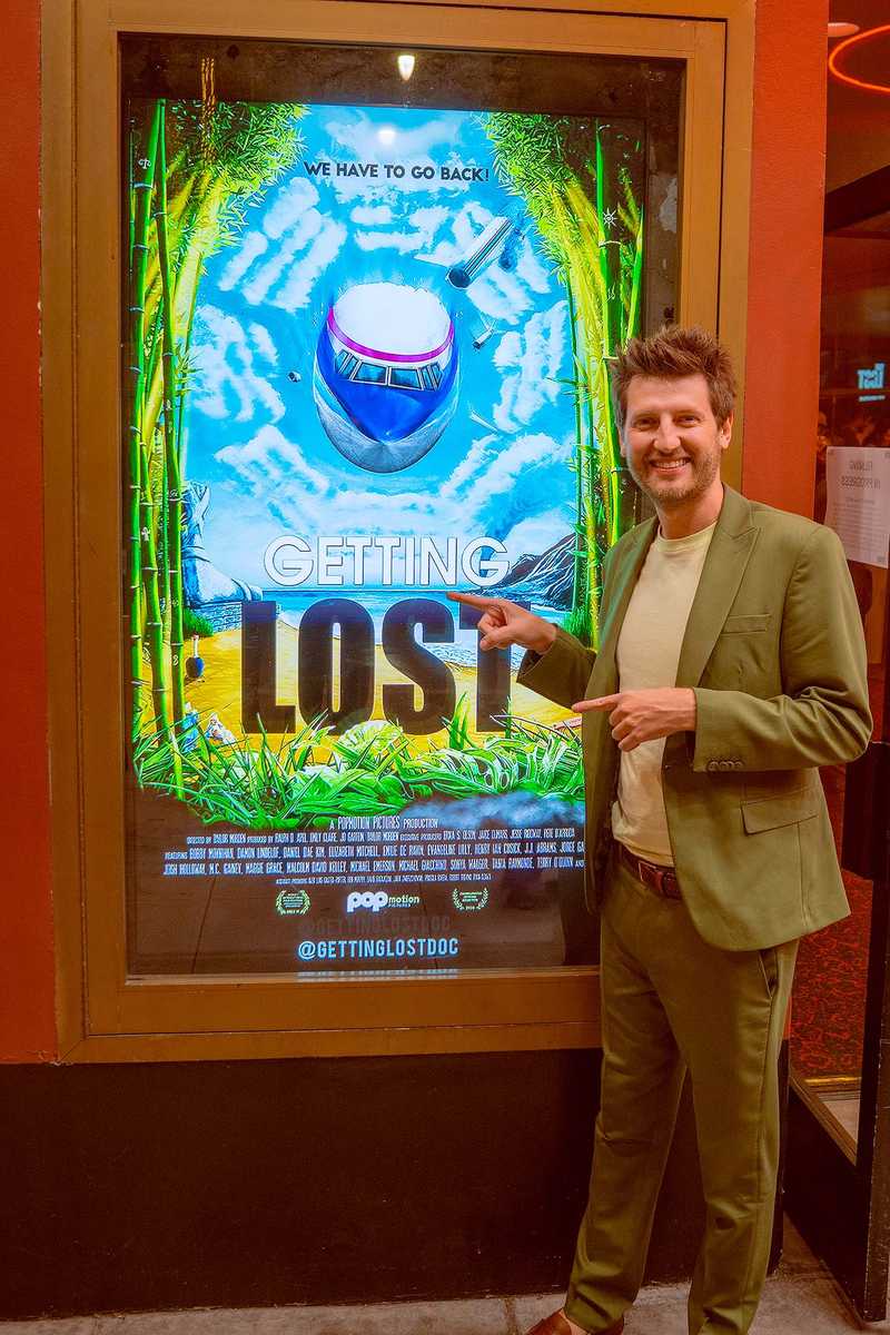 Caleb Woods next to Getting Lost poster